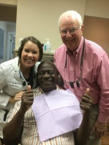 Dr. Mrgan Finkbine and Dr. Dale Finkbine smile with Herbert.