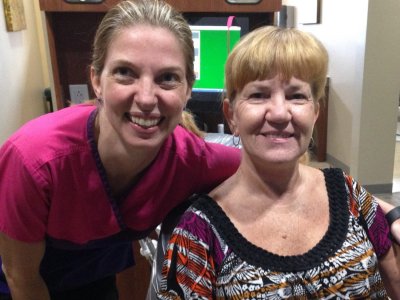 Young blonde dentist on the left and older woman patient on the right