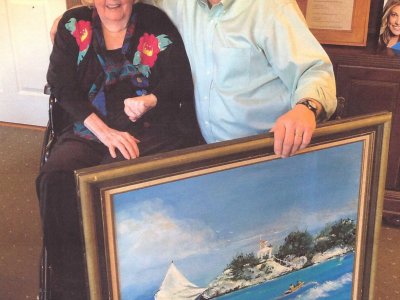 Myrtle and Dr. Ken Friday with patient’s artwork