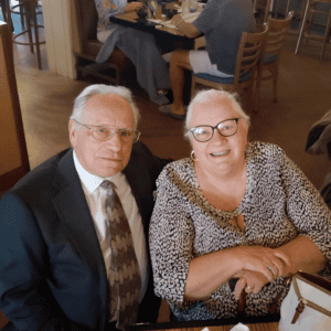 DDS Patients smiling while eating dinner out.