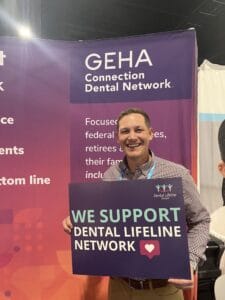 DLN Supporter Holding Supporter Sign and Smiling