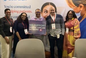 DLN Supporters Holding Supporter Sign and Smiling