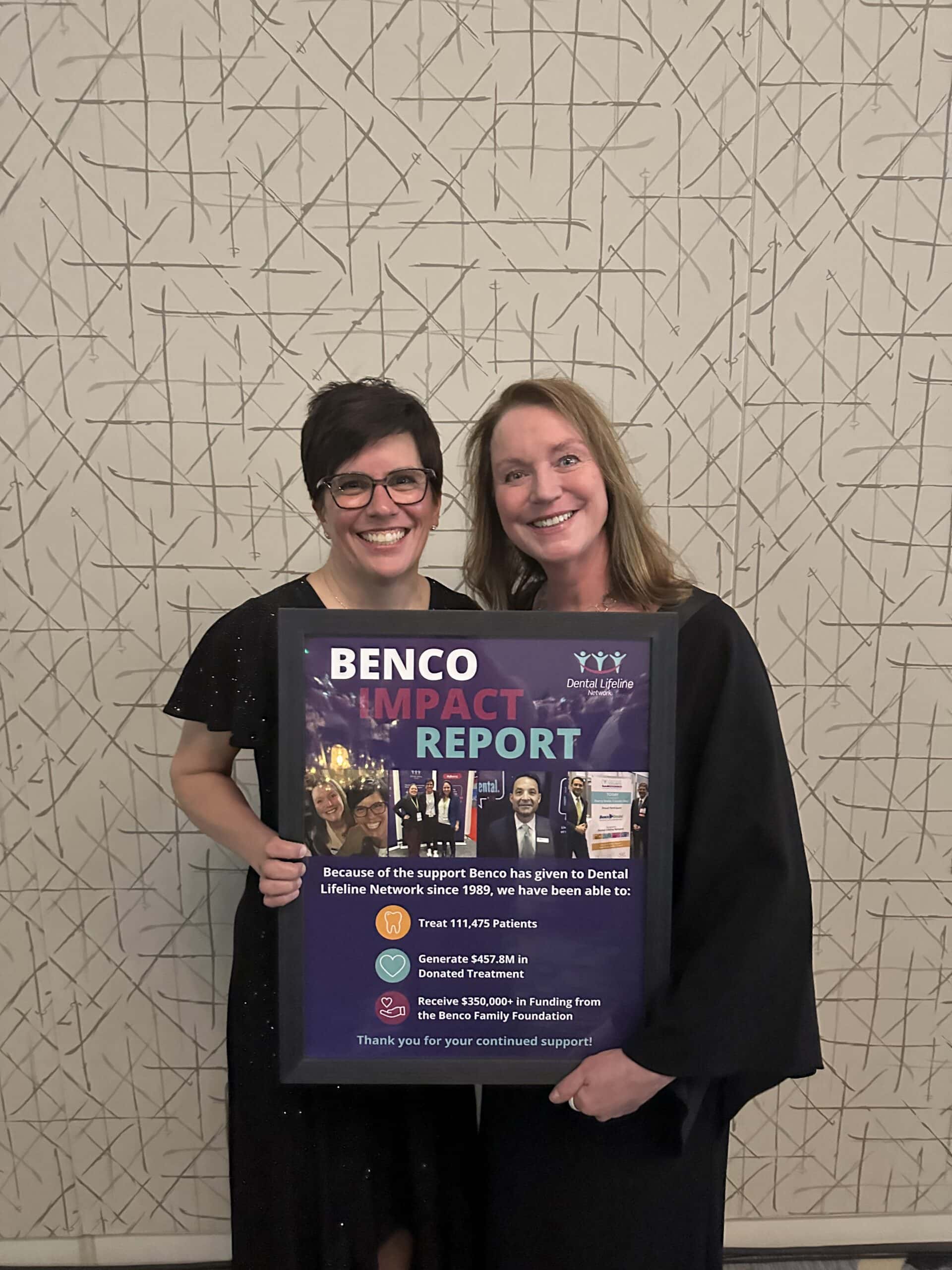 Lynda Ricketson and Julie Radzyminski smiling and holding impact report for Benco.